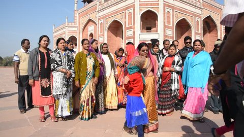 DELHI, INDIA, 13 FEBRUARY 2018 : Tourists visit the Humayun's Tomb. Humayun's Tomb is one of Delhi's most famous landmarks. The monument has an architectural design similar to the Taj Mahal.