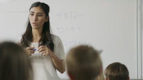 Tracking shot of teacher questioning students in math class / Provo, Utah, United States