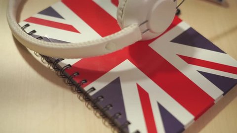 learning english courses logo concept with british flag and headphones. English school logotype