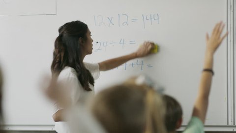 Panning shot of teacher questioning students in math class / Provo, Utah, United States