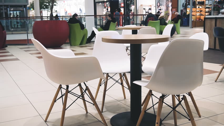 Pan shot of empty table in mall food court.