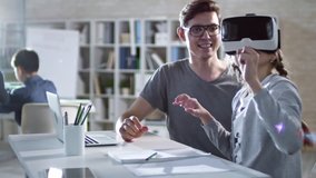 Girl of primary school age sitting in VR glasses and learning to use virtual reality with her teacher during computer coding class - Powered by Shutterstock - Get 15% off with code: PIKWIZARD15
