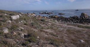 4K high quality aerial video footage of Western Cape's coast, Paternoster beach boulders, sandy sea front and Atlantic Ocean views in the background near Cape Town, South Africa on summer morning