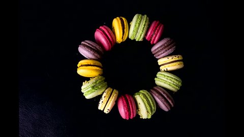 a lot of macaroons of different colors get together in a circle