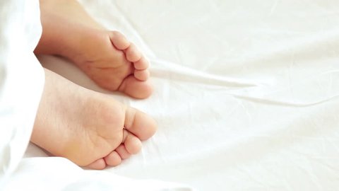 Feet of a sleeping child, squirming in the sleep