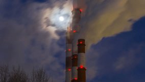  Gas Thermal power plant emits steam in the atmosphere on a cold moonlit night, time lapse