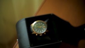 Man taking wrist watch close up. Clip. Man comes to the table and takes wristwatch. A man takes a wristwatch on the table