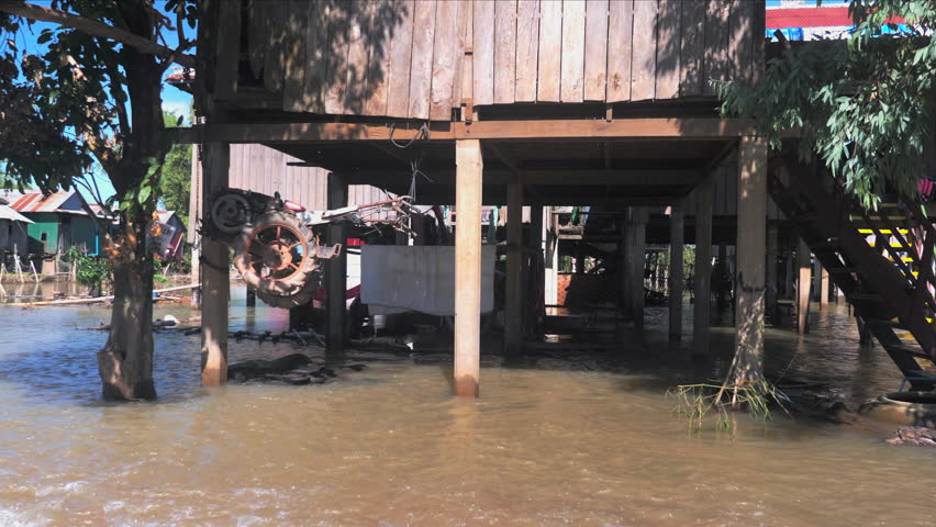 motorized cultivator hanging on the stilt of a flooded house ( close up )