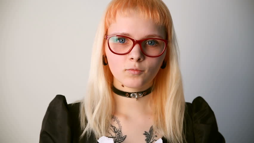 modern youth. calm portrait of a girl of unusual appearance with glasses.