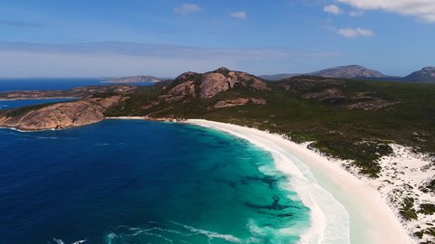 Aerial view of picturesque coastline scenery of Hellfire Bay, colorful cliffs and rocks, white sand beach and crystal clear water - Cape Le Grand, Esperance, Western Australia from above, 4k UHD