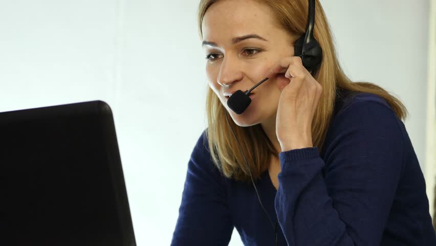 call center representative talking on helpline, Headset telemarketing positive female call center agent at work. 4K Royalty-Free Stock Footage #1008253951