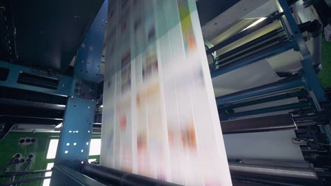 Printing of newspaper in a big amount. The process of offset and roll printing.