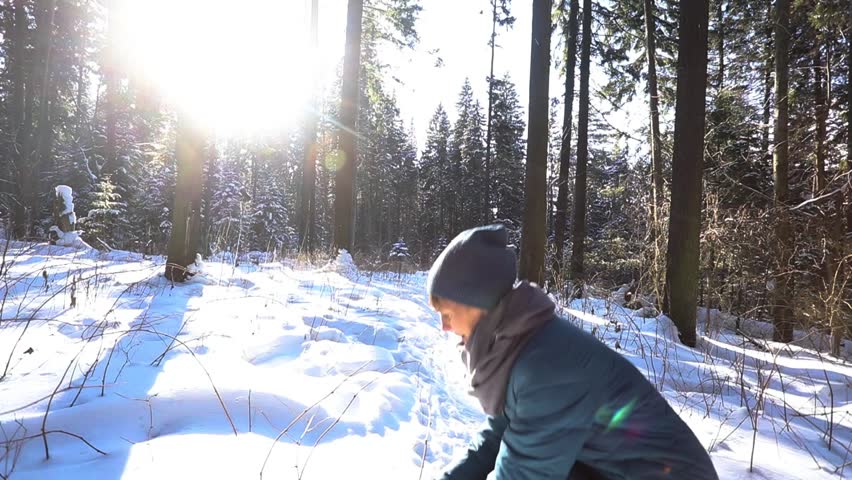SLOW MOTION: Happy young woman playing with snow