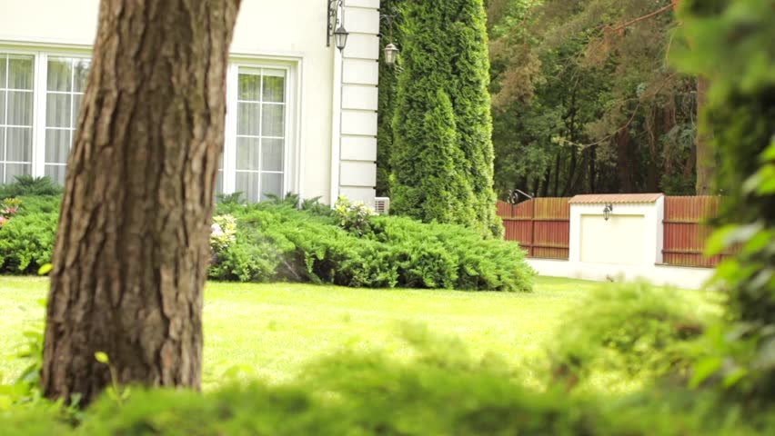 Working lawn watering system close to the mansion