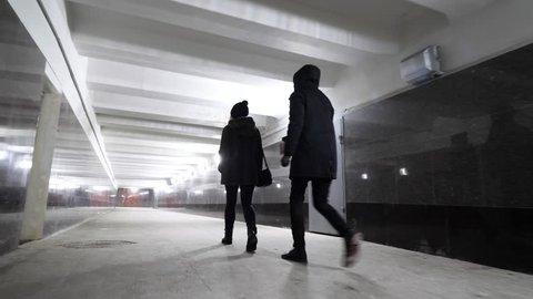 woman walking in a underground tunnel