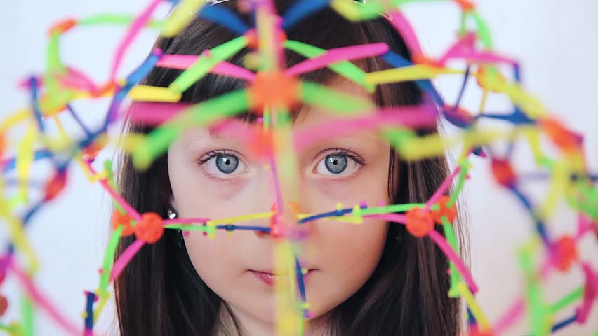 girl with colored transformer ball. child plays with transformer ball