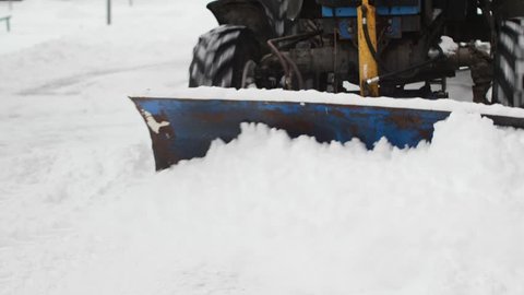 Tractor clears the way after heavy snowfall.
