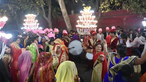 Agra / India 25 February 2018 A Marching wedding band and men women dancing in the streets This is an Indian wedding parade  at Agra  Uttar Pradesh  India