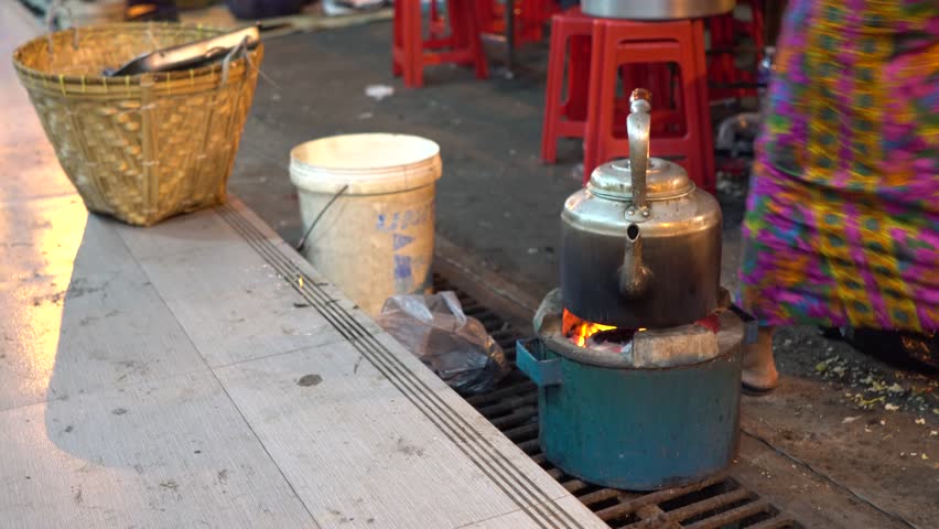 Old kettle on stove in temple fair Yangon, Myanmar