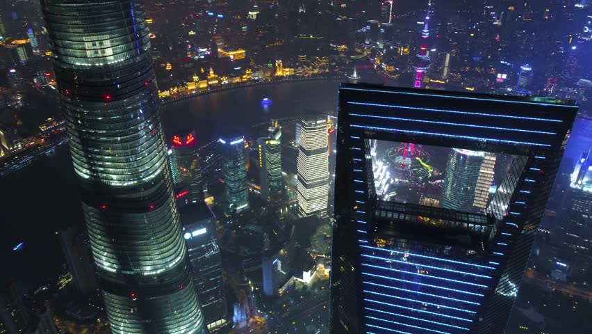 SHANGHAI, CHINA - MAY 5, 2017 Aerial drone video, night time illuminated famous pudong cityscape, business finance centre skyscrapers skyline, Huangpu river , historical and modern architecture, Bund
