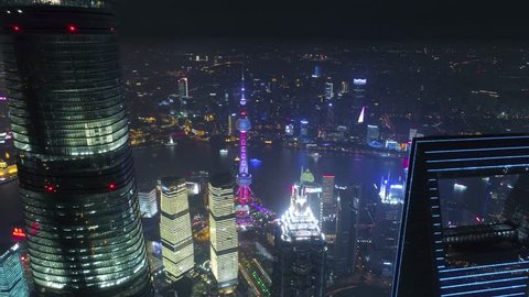 SHANGHAI, CHINA - MAY 5, 2017 Aerial drone video, night time illuminated famous pudong cityscape, business finance centre skyscrapers skyline, Huangpu river , historical and modern architecture, Bund