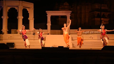 KHAJURAHO, INDIA 23 FEBRUARY 2018 : Dancers wearing traditional dresses hold a classic performance on stage, during the International Khajuraho Dance Festival in India.