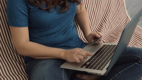 Slow Motion of woman in front of laptop holding credit card and smiling