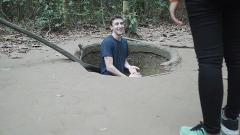 Smiling Man in bomb crater hole at Cu chi tunnels