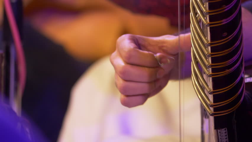 Hands of musician playing instrument Sitar shot in slow motion 100 fps. Royalty-Free Stock Footage #1008329419