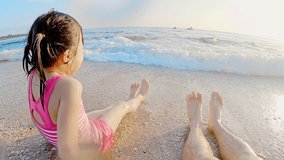 cute girl play water and sit on the beach