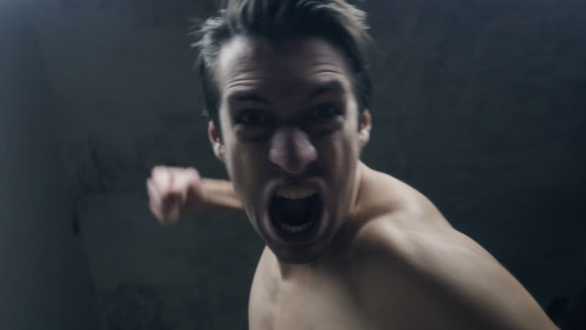 furious aggressive man beats with his fists the lying person