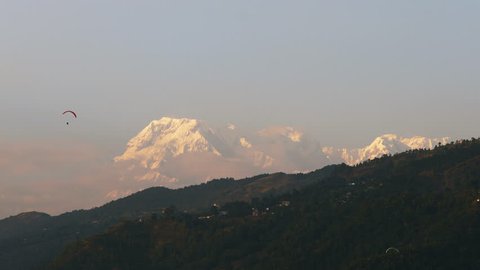Paragliders with Annapurna and Machapuchare mountain in the background, Pokhara, Nepal, Asia.