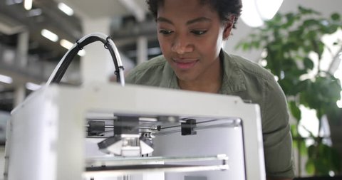 Female looking at 3D printer