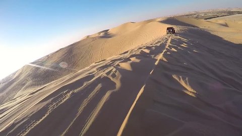 Driving with a four wheel drive through the desert of the United Arab Emirates near Abu Dhabi.