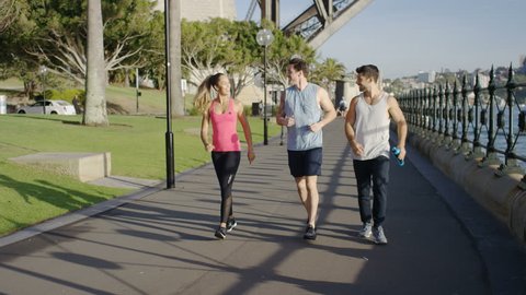 Group of young joggers finish their run and start talking to each other
