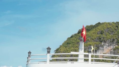 Halong Bay, Vietnam. Vietnamese flag with an island on the background. 150fps 1080p slomotion footage.