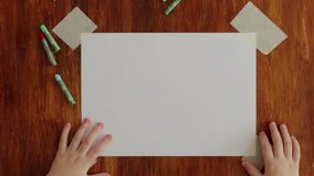 Boy is drawing green crocodile, top view stop motion video