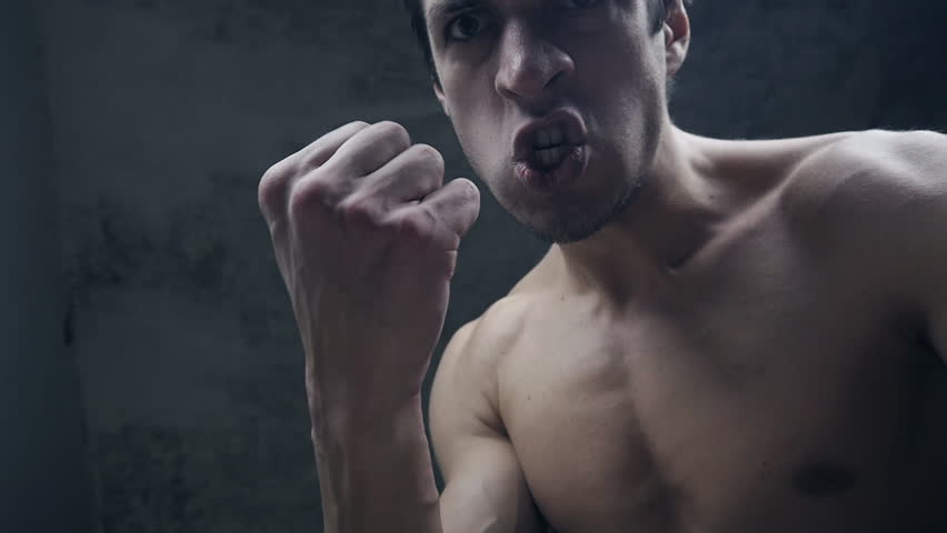 furious aggressive man beats with his fists the lying person