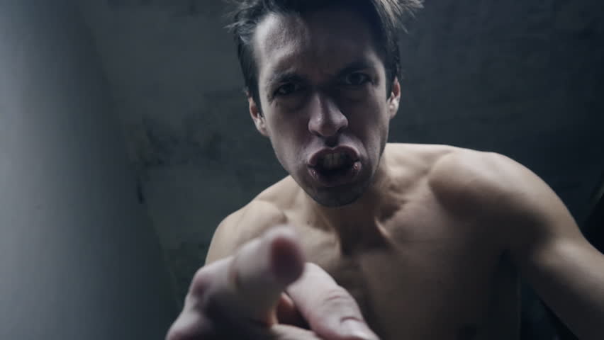 furious aggressive man beats with his fists the lying person