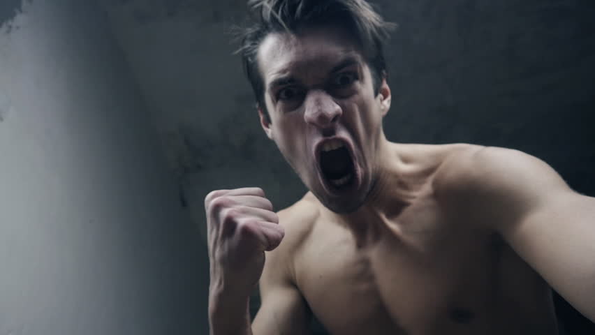 furious aggressive man beats with his fists the lying person