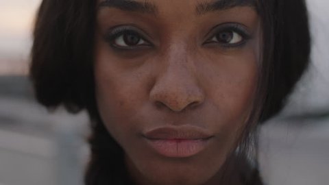 close up portrait of beautiful african american woman looking to camera intense focused