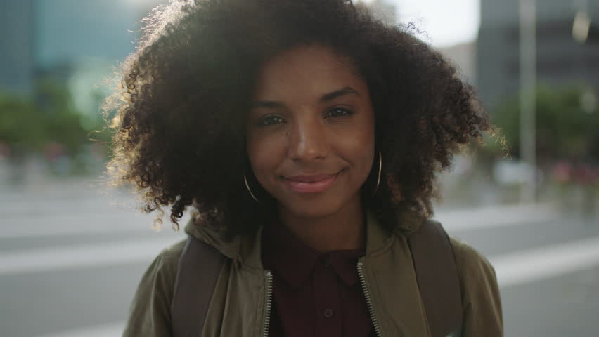 Portrait of beautiful trendy african american woman smiling at camera looking confident running hand through hair enjoying urban city lifestyle real people series | Shutterstock HD Video #1008365473