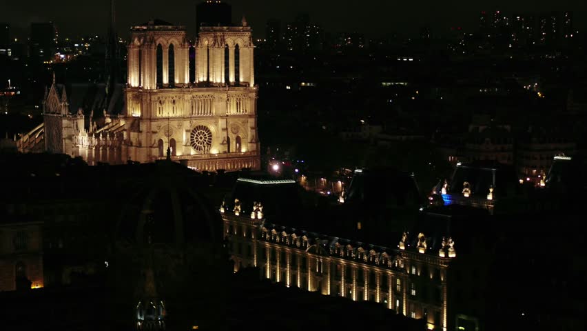Aerial discovery of Notre-Dame de Paris cathedral (before the fire) shot by night in Paris city, France.