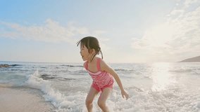 cute girl playing happily on the beach