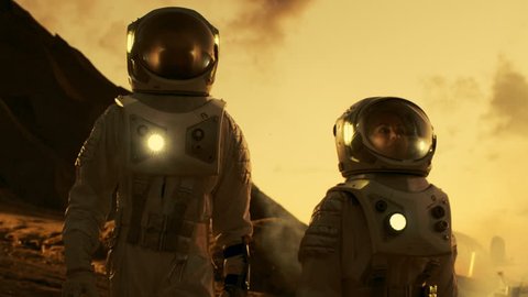 Two Astronauts Talking while Exploring Mars/ Red Planet. Space Exploration, Adventure and Colonisation Theme. Shot on RED EPIC-W 8K Helium Cinema Camera.