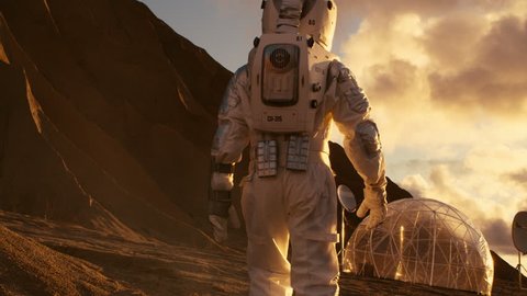 Following Shot of the Astronaut On Mars Walking Toward His Base/ Research Station. Manned Mission To Mars, Technological Advance Brings Space Exploration, Colonization. Shot on RED EPIC-W 8K Helium.