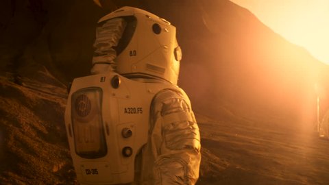 Following Shot of the Astronaut On Mars Walking Toward His Base/ Research Station. Near Future First Manned Mission To Mars, Technological Advance Brings Space Exploration, Colonization. 4K UHD.