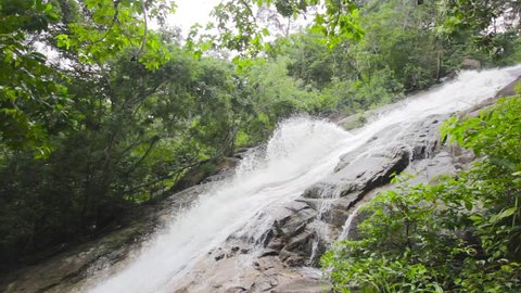 Waterfall in Gunung Ledang Malaysia , side view of waterfall  , green trees beside waterfall