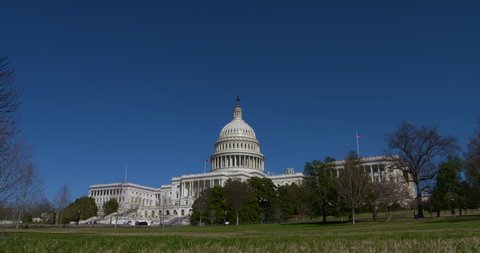 Very wide of the entire US Capitol Building with blue sky, late winter. 4K 