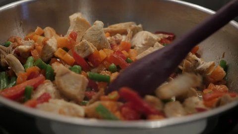 Preparing lunch in frying pan slow motion 1920X1080 HD video - Mixed vegetables with poultry meat slow-mo 1080p FullHD footage